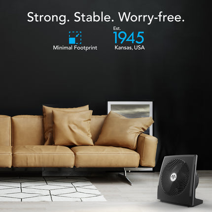 Brown leather sofa with decorative pillows in a room setting, featuring text about stability and a brand logo.