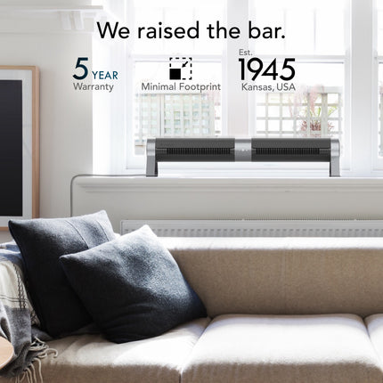 Modern living room with a tower fan and text about product features and establishment year.