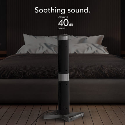 Black and silver fan on a wooden floor with a bedroom in the background, labeled 'Soothing sound. Down to 40 dB Level'.