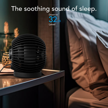 Black fan on a nightstand with text indicating a low noise level in a bedroom setting.