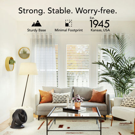 Living room with a gray sofa, coffee table, and decorative items, featuring text about stability and foundation.