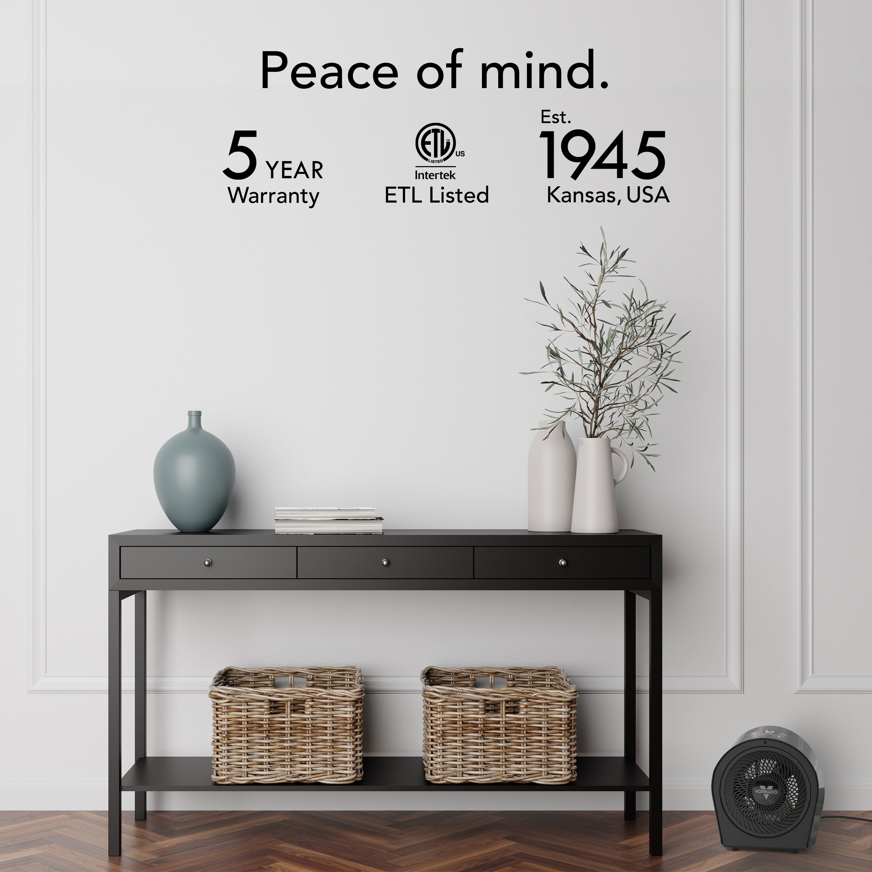 Black console table with decorative items in a room setting, featuring text about warranty and establishment details.