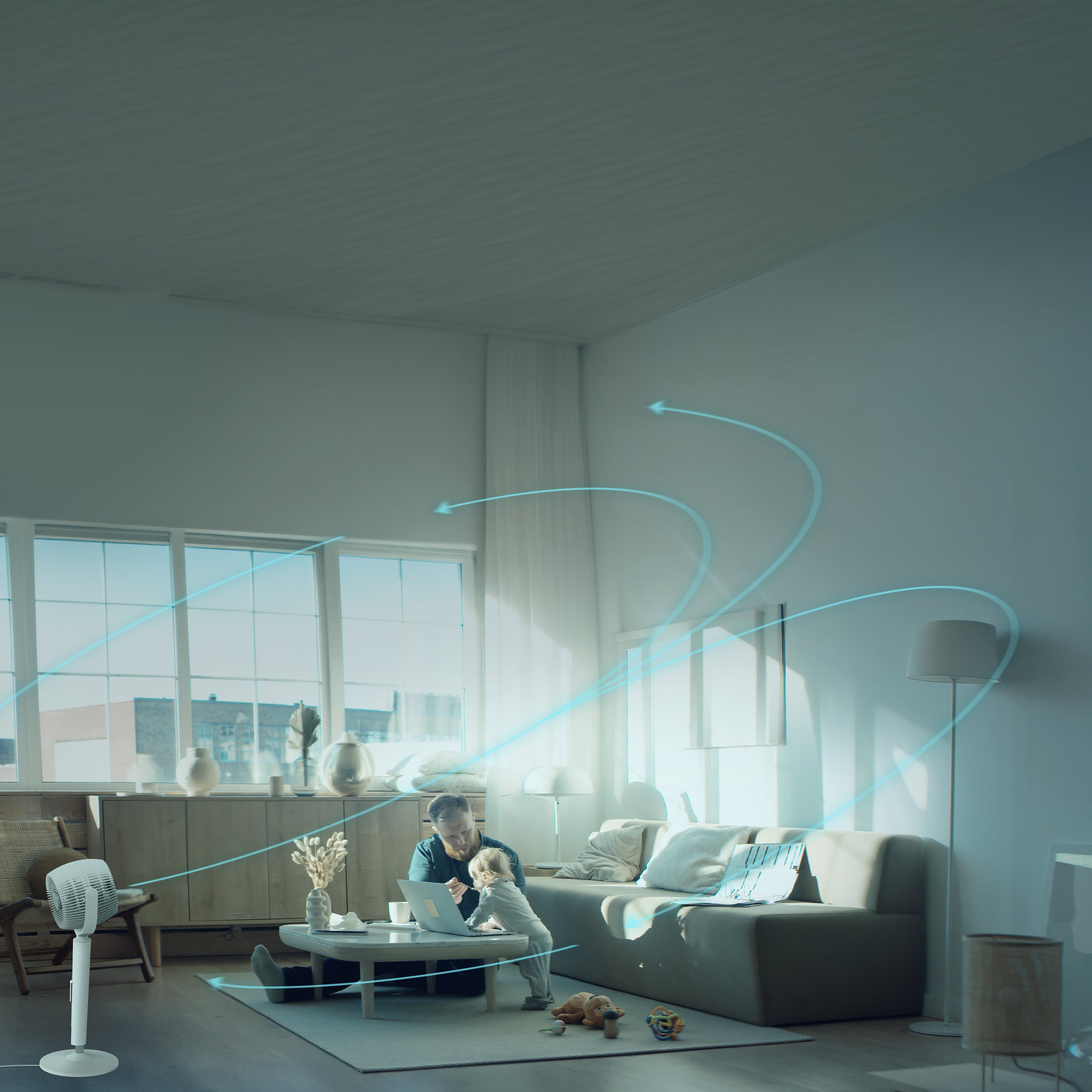 Modern living room with a man and child on a couch, large windows, and an EOS 9S circulating all the air in the room.