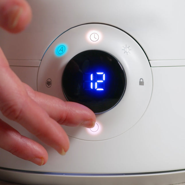 person turning dial on humidifier