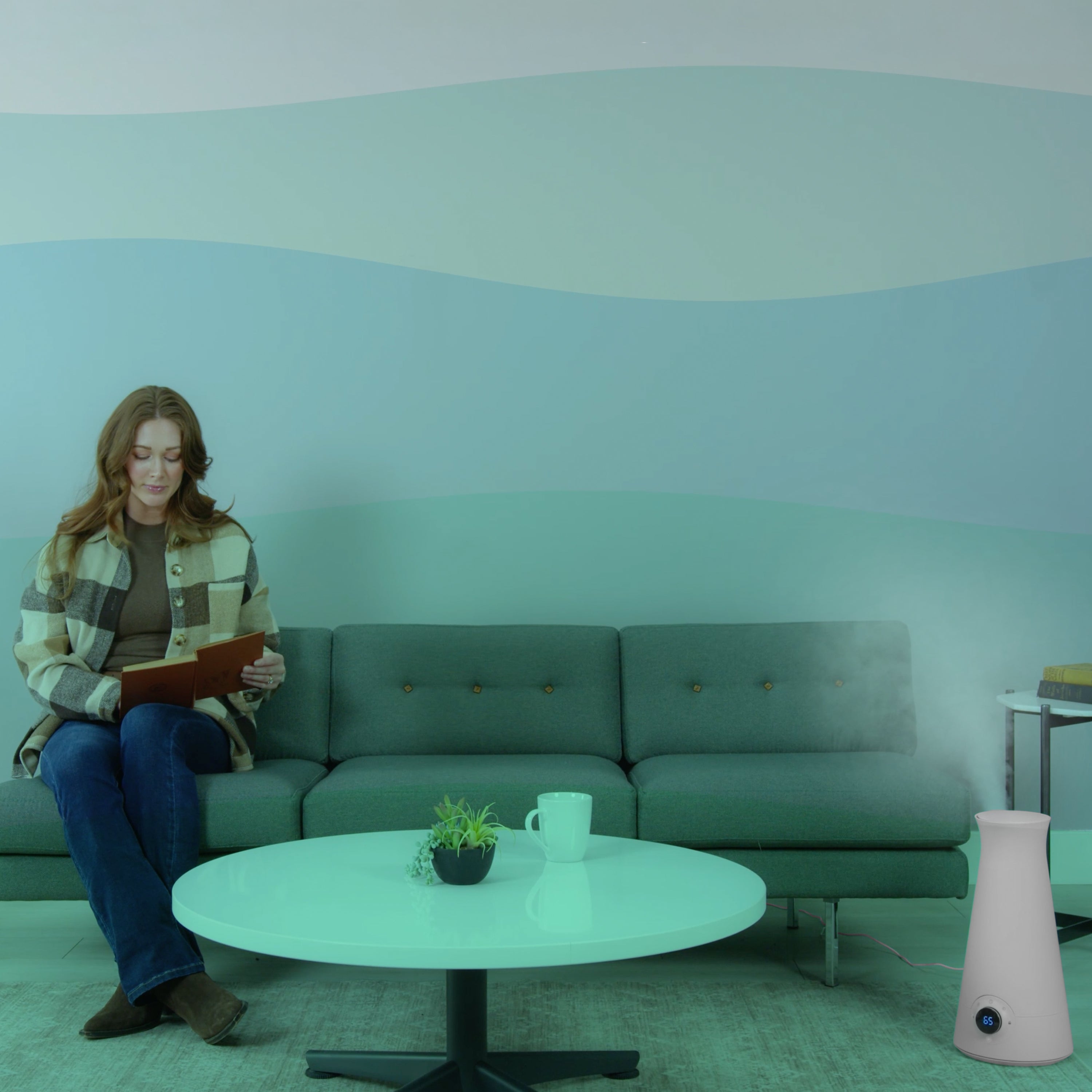 person sitting on couch in living room with a humidifier.