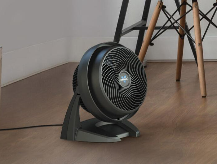 630 Air Circulator on a hard wood floor by a potted plant