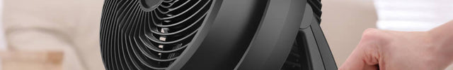 A person adjusting the control knob on the 630 air circulator.