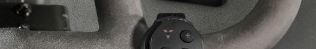 Vornado FLY MAX Remote attached to a stationary bike handle in front of a Vornado Fly Max