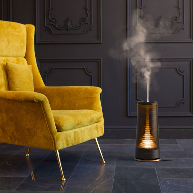 lucerna 3 humidifying in a dark stone floor room with modern accents next to a yellow chair