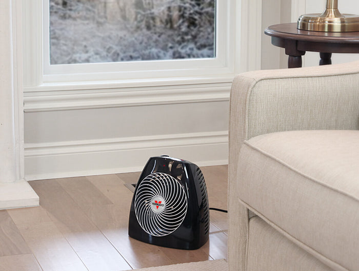MVH heater on a living room floor near a couch.