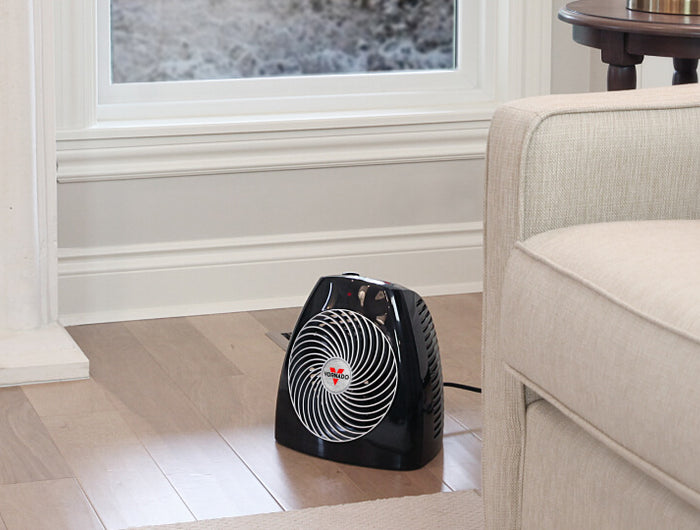 MVH heater on a living room floor near a couch.