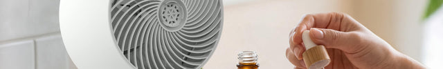 Person adding essential oil to a scent pad for Omnio 7's aromatherapy capabilities.