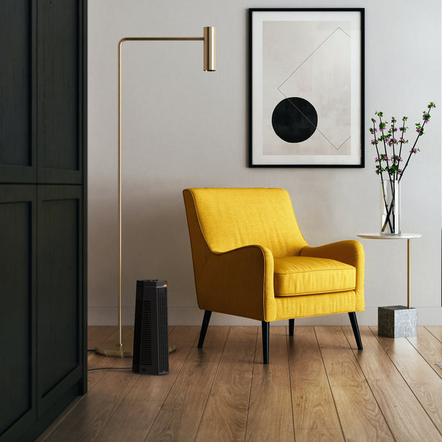 Yellow armchair in a modern room with a floor lamp and artwork on the wall.