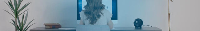 Woman at desk with sphere next to her. A transparent blue circle is over the woman indicating cool comfort.