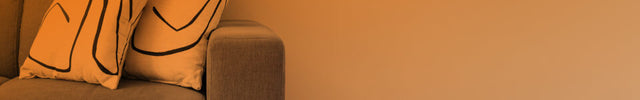 Part of a living room seen through an open door with an orange gradient to show whole room heat circulation. TAVH10 is on the floor near a couch.