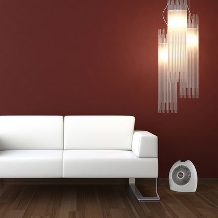 VH2 in a red room next to a white leather couch and below a hanging a chandelier