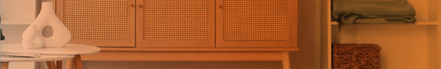 Part of a living room seen through an open door with an orange gradient to show whole room heat circulation. VMHi600 on the floor.