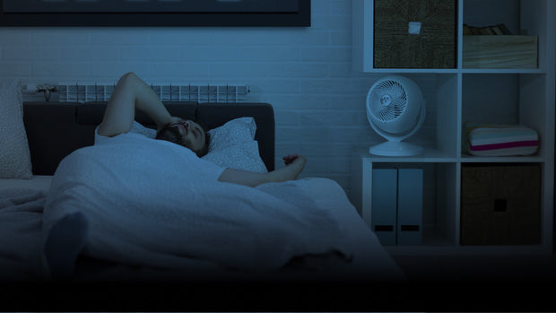 Man lying in bed in a dimly lit room utilizing Vora 8's sleep mode.