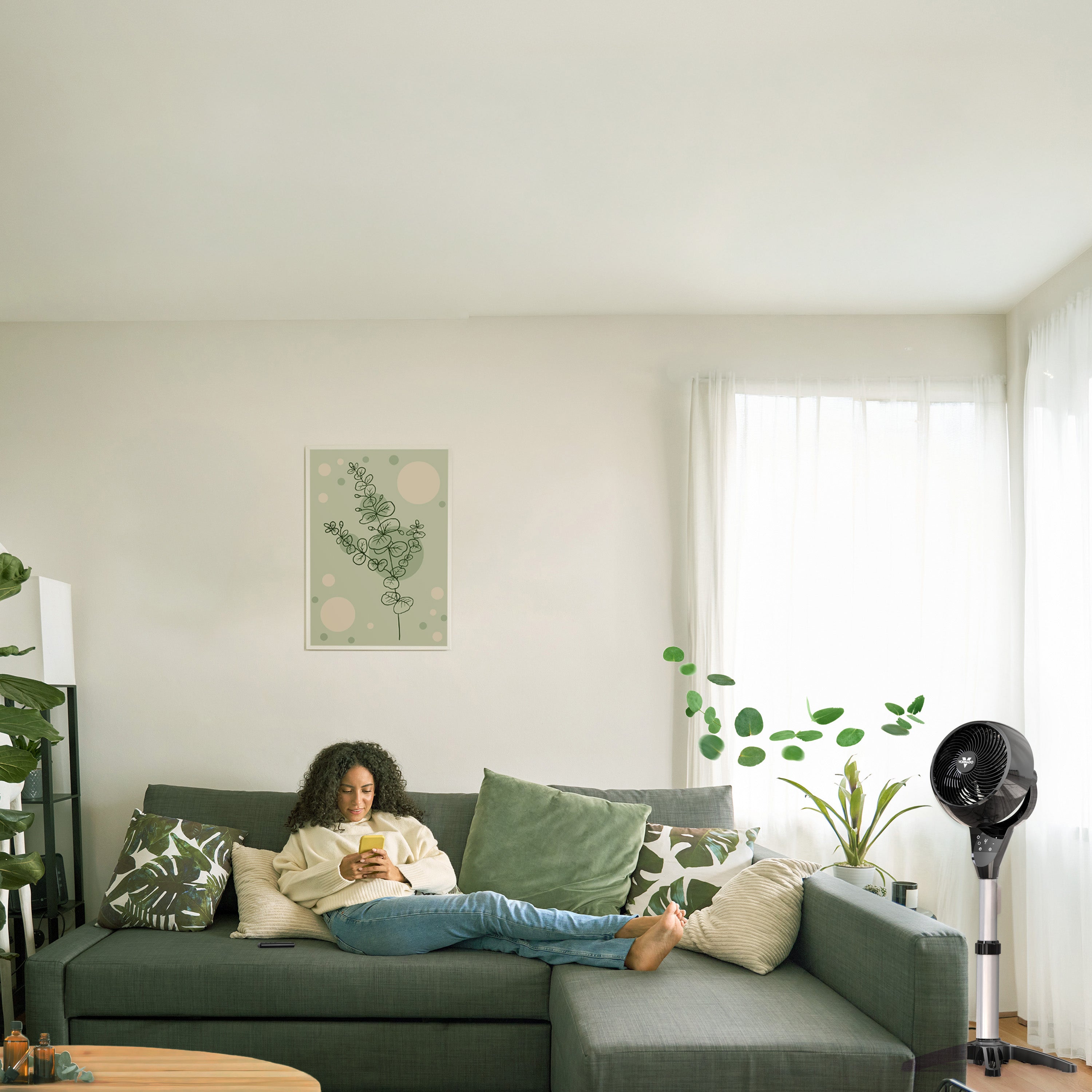Vornado 6803 OSC oscillating pedestal air circulator cooling a modern living room with whole-room air circulation.