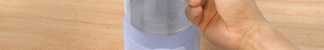 Image of a person removing Votiv 4's detachable tank from its base.