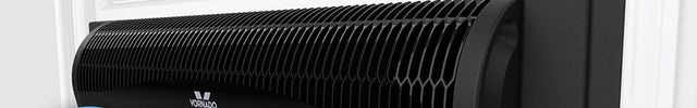 Vornado Transom Window Fan in a window with a city scape shown in the glass pane above it. There is a blue badge to the left of it that says Our Pick the New York Times Wirecutter 2025