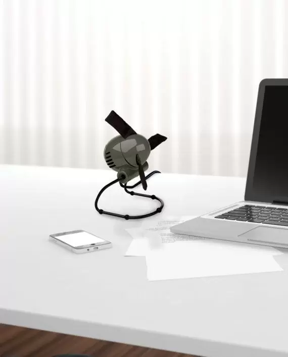 Graphite Grey Zippi personal fan on a desk by a laptop