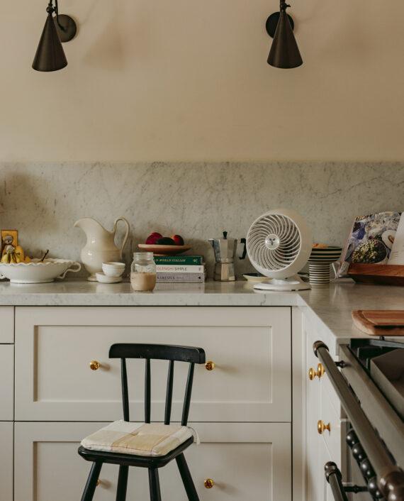 460 White sits on a kitchen countertop next to cookbooks and a stove range