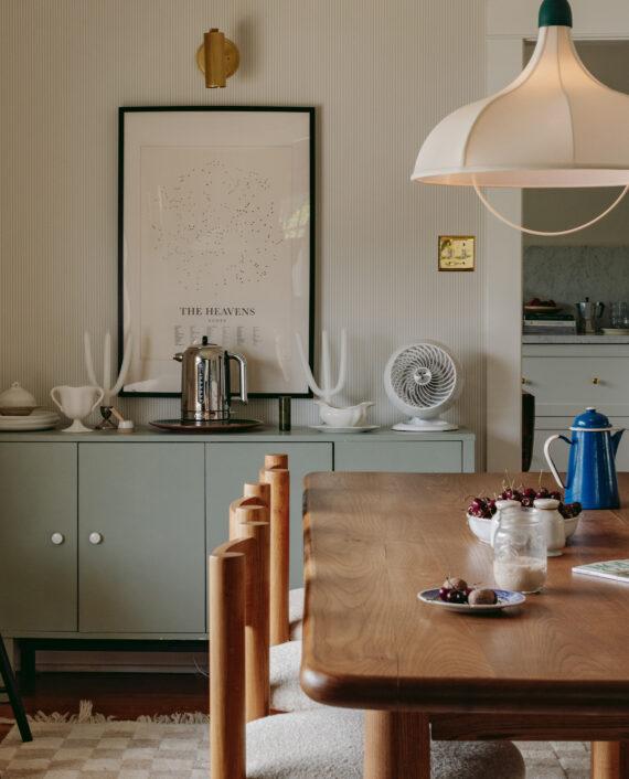 460 White sits on a light green credenza in a dining room. Dining room table is in foreground.