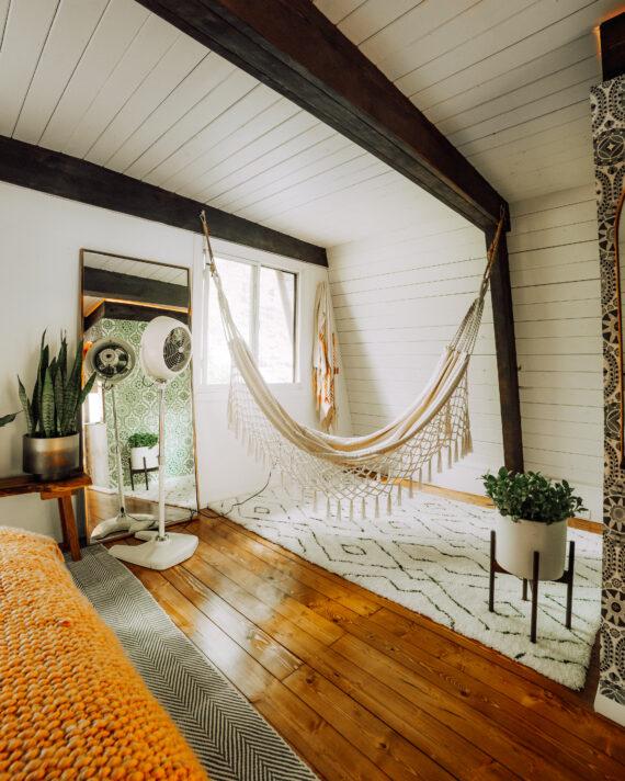 VFAN Sr Pedestal Vintage White in a boho-style room next to a macrame hammock