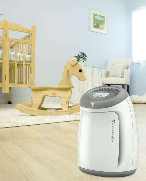 Lifestyle of a White Purios Nursery Air Purifier by a wooden rocking horse in a nursery