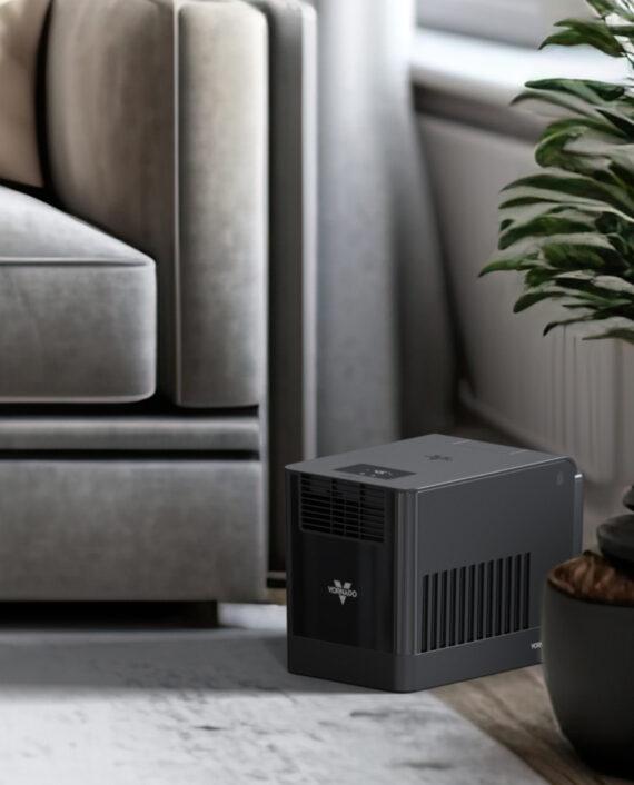 Lifestyle image of a EV3 Evaporative Whole Room Humidifier in a living room by a couch