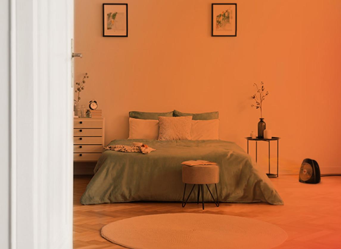 Bedroom through an open door with an orange gradient to show whole Room heat circulation