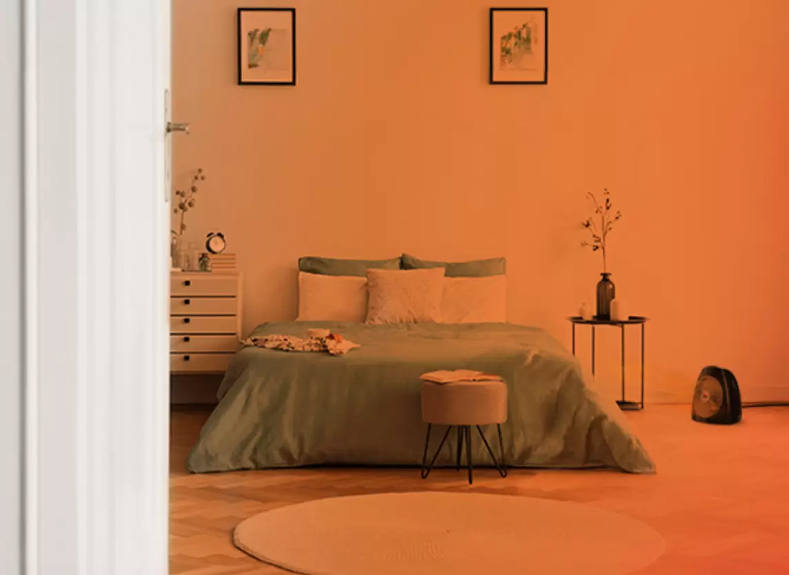 Bedroom through an open door with an orange gradient to show whole Room heat circulation