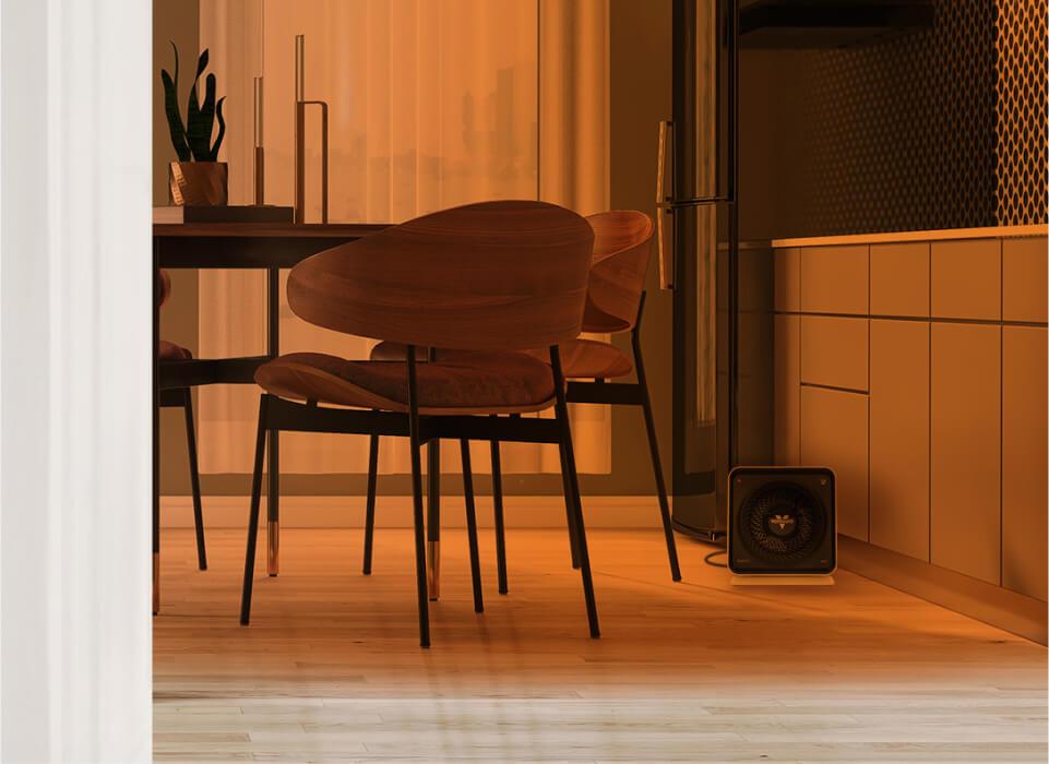 Kitchen through an open door with an orange gradient to show whole room heat circulation. Velocity Cube 5S is on the floor.